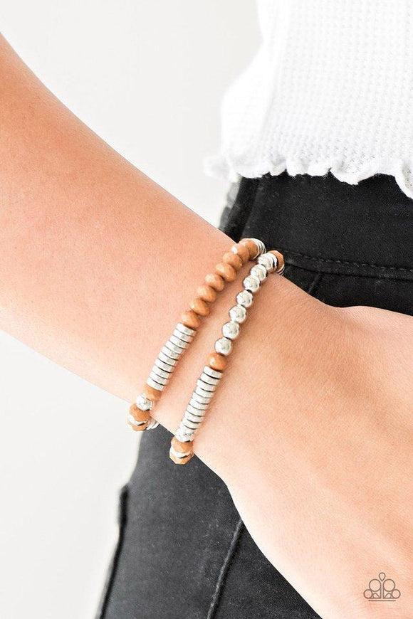 Paparazzi Downright Dressy - Brown - Bracelet
Classic silver beads, faceted Meerkat beads, and dainty silver discs are threaded along stretchy bands, creating shimmery layers across the wrist. 
