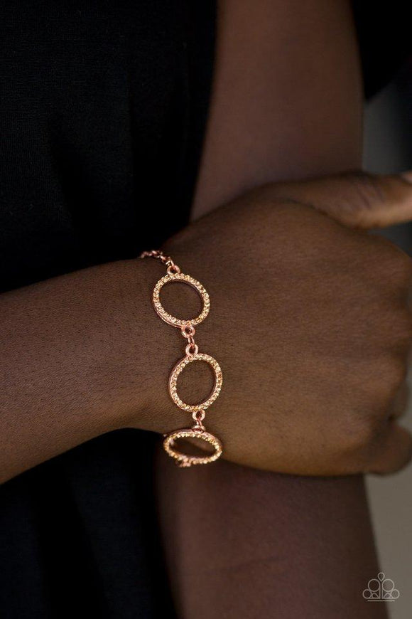 Paparazzi Dress The Part - Copper - Bracelet
Encrusted in glassy rhinestones, three shiny copper rings link across the wrist for a glamorous look. Features an adjustable clasp closure. 