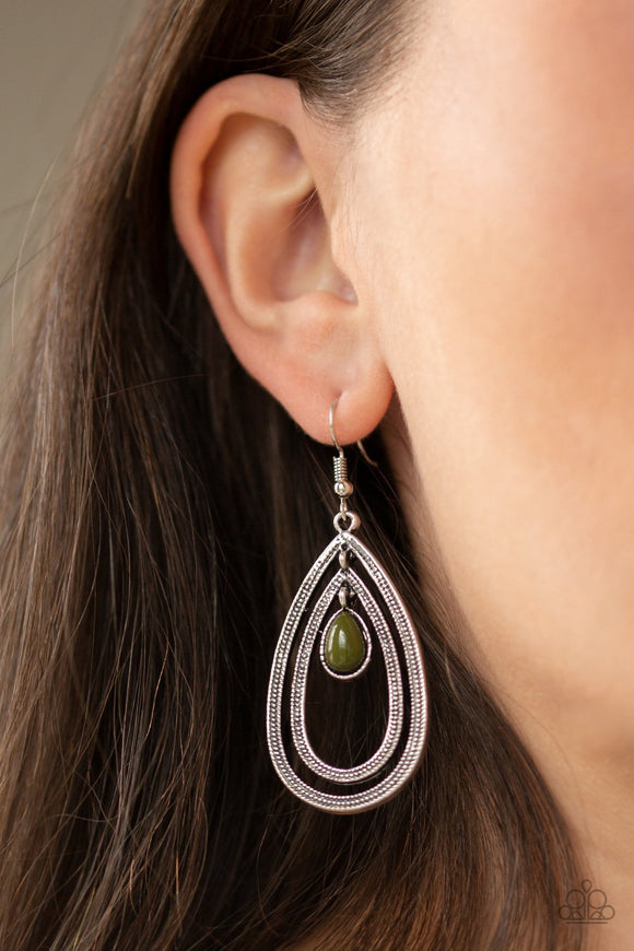 Paparazzi Drops Of Color - Green - Earrings
A green teardrop bead is nestled inside two silver teardrops radiating in studded textures, creating a dizzying lure. Earring attaches to a standard fishhook fitting.
