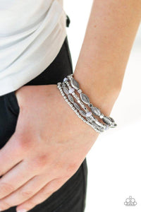 Paparazzi Full Of Wander - Silver - Bracelet
A collection of mismatched silver beads, silver cubes, and faceted gray beads are threaded along four stretchy bands around the wrist for a colorful flair. 