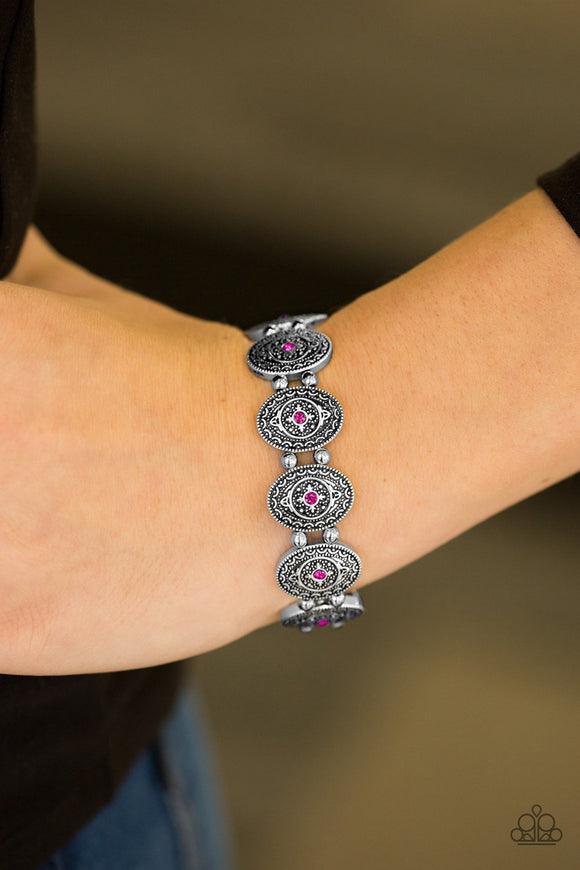 Paparazzi Girl Grandeur - Pink Glittery pink rhinestones are pressed into the centers of ornate silver frames. Infused with classic silver beads, the dainty frames are threaded along elastic stretchy bands, creating a whimsical look around the wrist.

