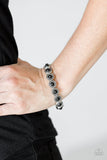 Paparazzi Globetrotter Goals - Black - Bracelet
Dotted with shiny black beaded centers, studded silver frames are threaded along stretchy elastic bands and linked around the wrist for a whimsical look.
