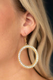 Paparazzi Haute Halo - Gold Earrings
Encrusted in a glittery ring of white rhinestones, a studded gold hoop swings from the ear for a dramatic look. Earring attaches to a standard fishhook fitting. 