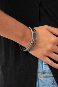 Paparazzi Heap It On - Black Gunmetal - Bracelet
Pairs of smooth and hammered gunmetal bangles join a white rhinestone encrusted bracelet around the wrist, creating an edgy stack of sparkle.
