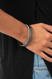 Paparazzi Heap It On - Black Gunmetal - Bracelet
Pairs of smooth and hammered gunmetal bangles join a white rhinestone encrusted bracelet around the wrist, creating an edgy stack of sparkle.
