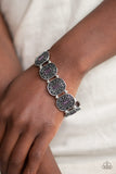 Paparazzi Hidden Fortune - Purple - Bracelet
Featuring purple emerald-cut rhinestone centers, ornate silver frames are threaded along stretchy bands around the wrist for a refined fashion.

