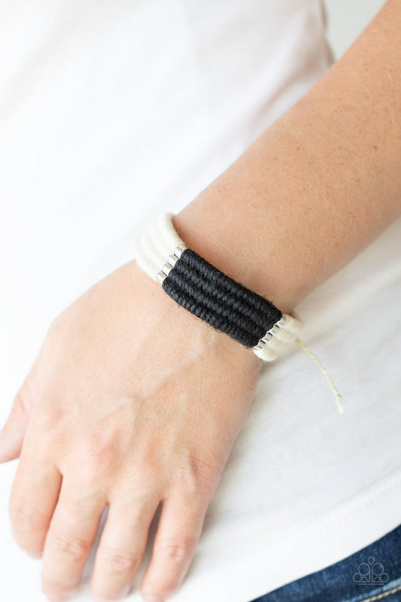 Paparazzi Hot Cross Bungee - Black - Bracelet
Infused with metallic frames, rows of white and black twine-like cording knot into an earthy display around the wrist. Features an adjustable sliding knot closure.
