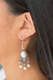 Paparazzi I Better Get GLOWing - White - Earrings
Dotted silver filigree spins around a pearly white bead and dainty white rhinestones, coalescing into a regal frame. A pearly fringe swings from the bottom of the frame for a refined finish. Earring attaches to a standard fishhook fitting.
