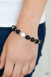 Paparazzi Intent - White - Bracelet
An earthy collection of shiny silver accents, black lava rock beads, and a single white stone bead is threaded along a stretchy band around the wrist for a seasonal flair.
