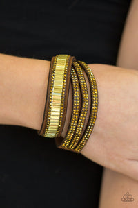 Paparazzi Just In SHOWTIME - Brass - Bracelet
Encrusted in mismatched sparkle, half of a brown suede band is encrusted in topaz emerald style cut rhinestones, while the other half splits into three separate bands encrusted in aurum rhinestones for a sassy look. The elongated band allows for a trendy double wrap design. Features an adjustable snap closure.
