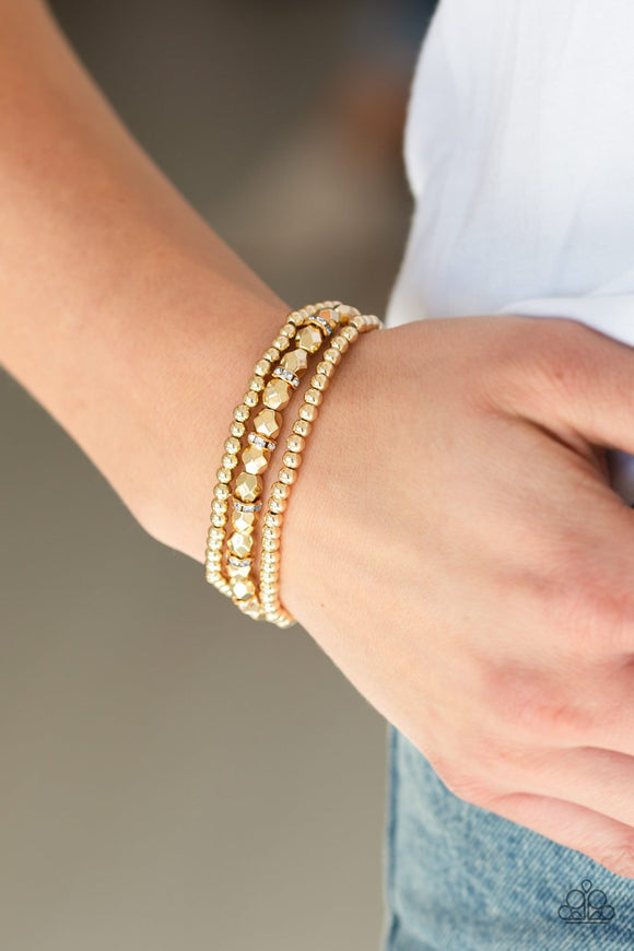 Paparazzi Let There BEAM Light - Gold - Bracelet
Infused with white rhinestone encrusted rings, mismatched dainty silver and faceted gold beads are threaded along stretchy bands for a refined look.
