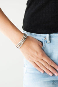 Paparazzi Let There BEAM Light - Silver - Bracelet
Infused with hematite rhinestone encrusted rings, mismatched dainty silver and faceted silver beads are threaded along stretchy bands for a refined look. 