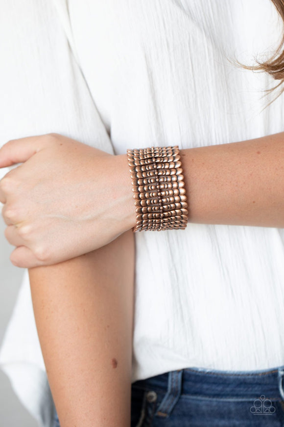 Paparazzi Level The Field - Copper - Bracelet
Infused with dainty copper beads, rippling copper bars are threaded along stretchy bands around the wrist, creating a rustic centerpiece.
