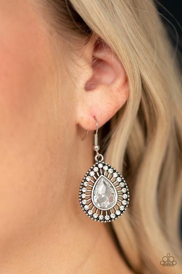 Paparazzi Limo Service - White - Earrings
A teardrop white rhinestone is pressed into an ornate silver teardrop frame radiating with dainty white rhinestones for a refined flair. Earring attaches to a standard fishhook fitting.