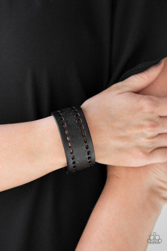 Paparazzi Make The WEST Of It - Black - Bracelet
Stamped in a southwestern textile inspired pattern, a shiny black leather band wraps around the wrist for a seasonal look. Features an adjustable snap closure. 
