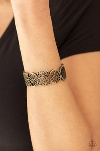 Paparazzi Mandala Mixer - Brass - Bracelet
Brushed in an antiqued shimmer, a collection of mandala-like brass frames connect into a bold cuff-like bracelet around the wrist. Features a hinged closure. 