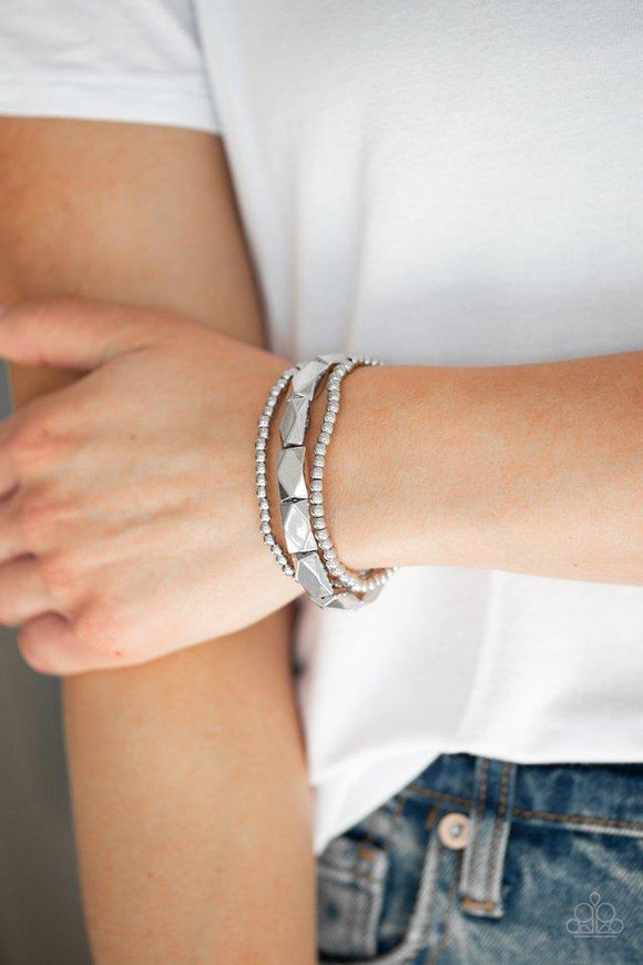 Paparazzi Metal Movement - Silver - Bracelet
Dainty silver beads and faceted silver accents are threaded along stretchy bands and stacked across the wrist for a bold industrial look.

All jewelry is Lead & Nickel Free!