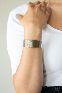 Paparazzi Mixed Vibes - Brass - Bracelet
One half of a thick brass cuff is engraved in stacked linear lines while the other half is hammered in a row of tactile textures, creating a collision of texture around the wrist.