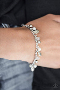 Paparazzi Modestly Midsummer - White - Bracelet
Pearly white and crystal-like beads trickle from a silver chain, creating a bubbly fringe around the wrist. Faceted silver teardrops drip between the colorful beading, adding a timeless shimmer to the seasonal look. Features an adjustable clasp closure. 
