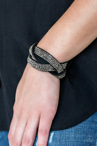 Paparazzi Nice Girls Finish Last - Black - Bracelet
Encrusted in row after row of glittery hematite rhinestones, three black suede bands braid across the wrist for a sassy look. Features an adjustable snap closure.
