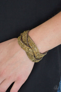 Paparazzi Nice Girls Finish Last - Brass - Bracelet
Encrusted in row after row of glittery aurum rhinestones, three sparkling brown suede bands braid across the wrist for a sassy look. Features an adjustable snap closure.
