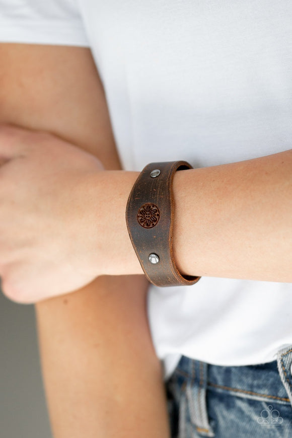 Paparazzi Pleasantly Pioneer - Brown - Bracelet
Infused with metallic studs, a distressed brown leather band is stamped in floral detail for a seasonal look. Features an adjustable snap closure.
