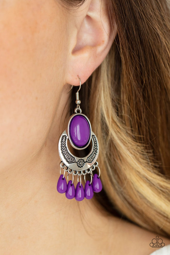 Paparazzi Prairie Flirt - Purple - Earrings
Amethyst Orchid teardrop beads dance from the bottom of a half-moon silver frame stamped in floral detail, creating a flirty fringe. An oversized Amethyst Orchid oval bead crowns the top of the frame for a powerful pop of color. Earring attaches to a standard fishhook fitting.