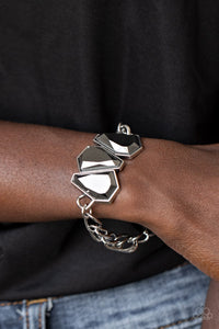 Paparazzi Raw Radiance - Silver - Bracelet
Attached to a shiny silver chain, a trio of sparkly hematite gem-shaped rhinestones join into a glamorous centerpiece atop the wrist. Features an adjustable clasp closure.
