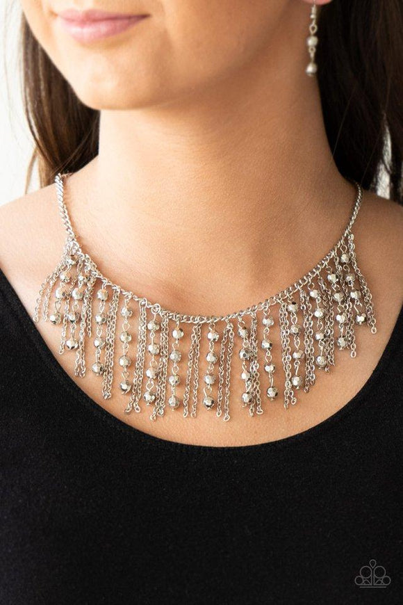 Paparazzi Rebel Remix - Silver - Necklace
Stands of faceted silver beads and glistening silver chains stream from a matching silver chain, creating an edgy fringe below the collar. Features an adjustable clasp closure.