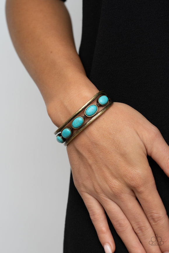 Paparazzi River Rock Canyons - Brass - Bracelet
A refreshing collection of oval turquoise stones are studded across the airy center of a layered brass cuff for a rustic flair.
