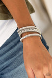 Paparazzi Rollin In Rhinestones - Silver - Bracelet
Rows of glassy white rhinestones and a shimmery silver chain are encrusted along gray suede bands for a sassy look. Features an adjustable snap closure.
