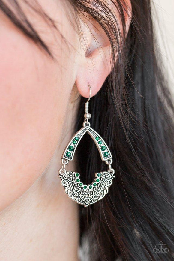 Paparazzi Royal Engagement - Green - Earrings
Encrusted in glittery green rhinestones, an arcing silver frame links with an ornate silver frame radiating with filigree filled details for a refined look. Earring attaches to a standard fishhook fitting.