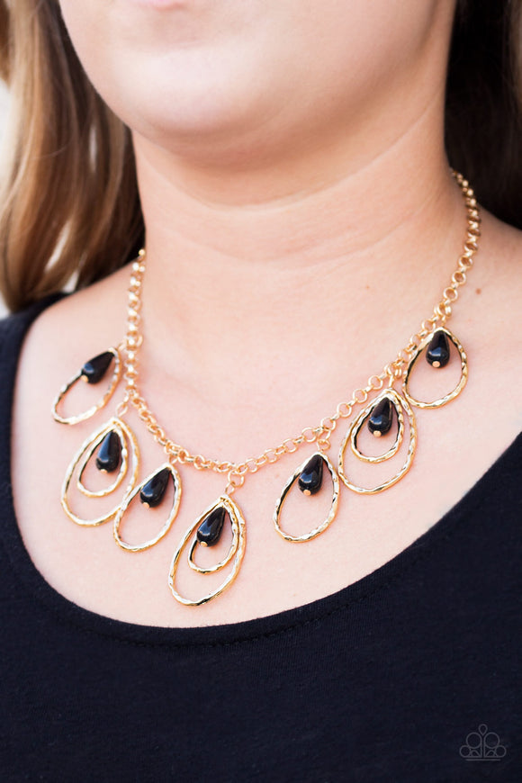 Paparazzi Rustic Ritz - Gold - Necklace
Shiny black teardrop beads swing from the tops of delicately hammered gold teardrop frames, creating a refined fringe below the collar. Features an adjustable clasp closure.