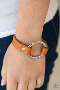 Paparazzi Rustic Rodeo - Yellow - Bracelet
Infused with pieces of shiny yellow leather, an oversized silver ring is studded in place atop the center of the wrist for a rustic flair. Features an adjustable snap closure. 
