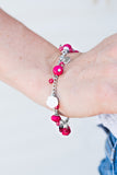 Paparazzi Spoken For - Pink - Bracelet
Tinted in the vivacious hue of Love Potion, faceted pink beads swing from the wrist in a flirtatious fashion. Infused with dainty crystal-like accents and shiny silver discs, white resin roses trickle between the colorful beading for a feminine finish. Features an adjustable clasp closure.
