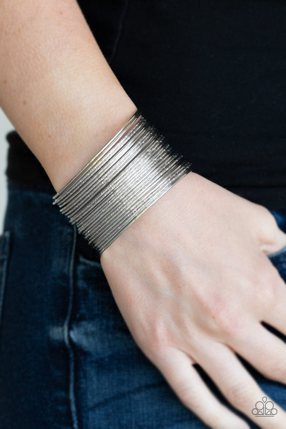 Paparazzi Stacked To The Max - Silver - Bracelet
An assortment of smooth and hammered silver bars arc across the wrist, stacking into a bold bangle-like cuff.
