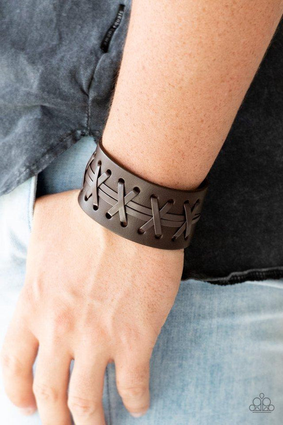 Paparazzi Super Sporty - Brown - Bracelet
Brown leather cording is laced across the front of a thick leather band for a rugged look. Features an adjustable snap closure. 
