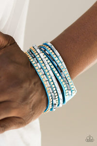Paparazzi This Time With Attitude - Blue - Bracelet
Smoky and white emerald cut rhinestones and flat gold cube beads are encrusted along strands of blue suede for a sassy look. The elongated band double wraps around the wrist for a fierce one-of-a-kind look. Features an adjustable snap closure.
