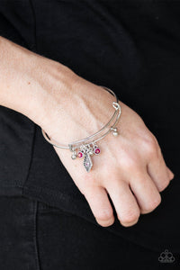Paparazzi Treasure Charms - Pink - Bracelet
A collection of shimmery silver beads and glittery pink rhinestone accents slide along a sleek bar fitting, creating whimsical charms as they glide along the dainty silver bangle.

