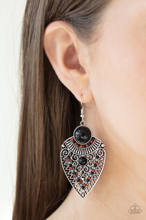 Paparazzi Tribal Territory - Black - Earrings
Black, Cinnamon Stick, and Ash beads decorate the front of a spade shaped silver frame radiating with linear and zigzagging details for a tribal inspired look. Earring attaches to a standard fishhook fitting.