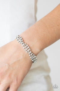 Paparazzi Twists And Turns - White - Bracelet
Featuring glistening silver fittings, strands of glittery white rhinestones delicately braid around the wrist for a glamorously layered look. Features an adjustable clasp closure.
