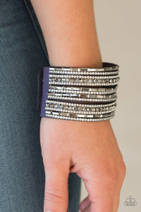 Paparazzi Wham Bam Glam - Blue - Bracelet
Varying in size and shape, glassy white and smoky hematite rhinestones are encrusted along strands of blue suede for a sassy look. Features an adjustable snap closure.
