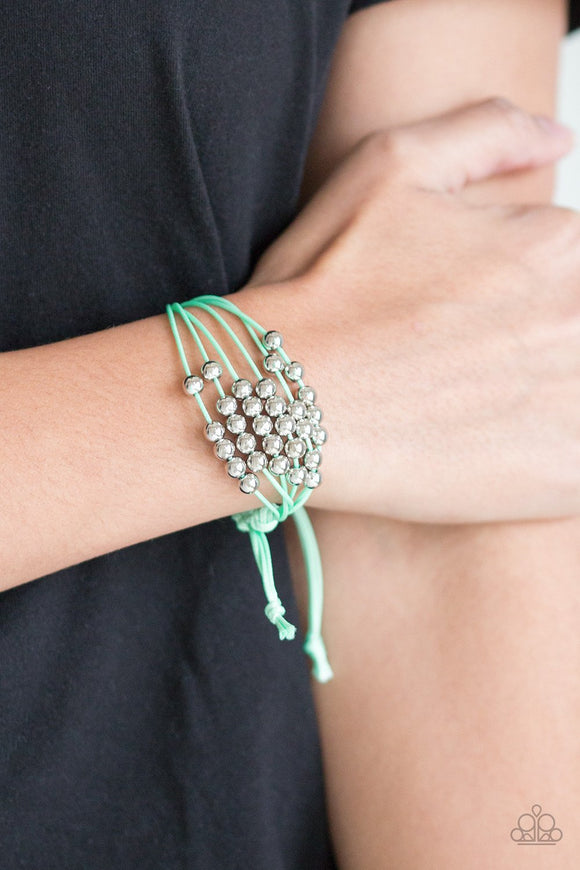 Paparazzi Without Skipping A BEAD - Green - Bracelet
Shiny silver beads are threaded along row after row of shiny green cording around the wrist for a colorful look. Features an adjustable sliding knot closure.
