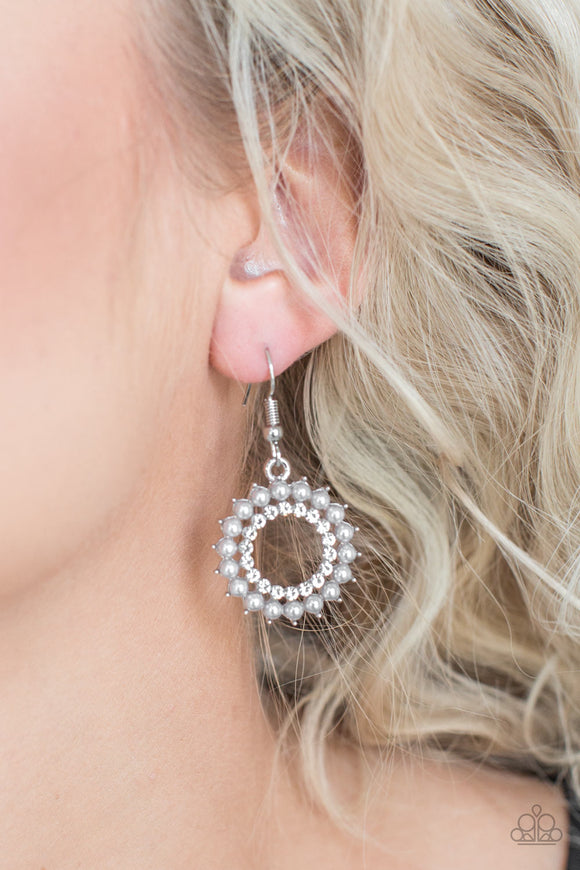 Paparazzi Wreathed In Radiance - Silver - Earrings
Dainty silver pearls spin around a radiant white rhinestone center, coalescing into a refined hoop. Earring attaches to a standard fishhook fitting.