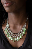 Paparazzi Spring Daydream - Green Infused with a row of thick silver chain, faceted silver and glassy green beads swing from the bottom of ornate silver links, creating a vivacious fringe below the collar. Features an adjustable clasp closure.

