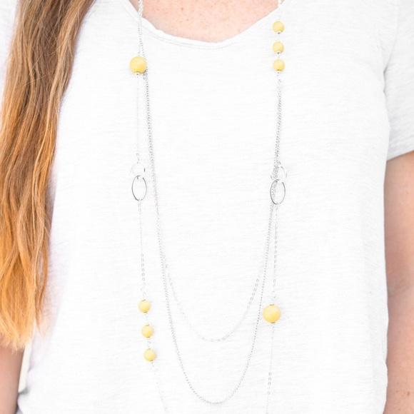 Paparazzi Beachside Babe - Yellow Featuring vivacious yellow beads and shimmery silver hoops, mismatched silver chains layer down the chest for a seasonal look. Features an adjustable clasp closure.

